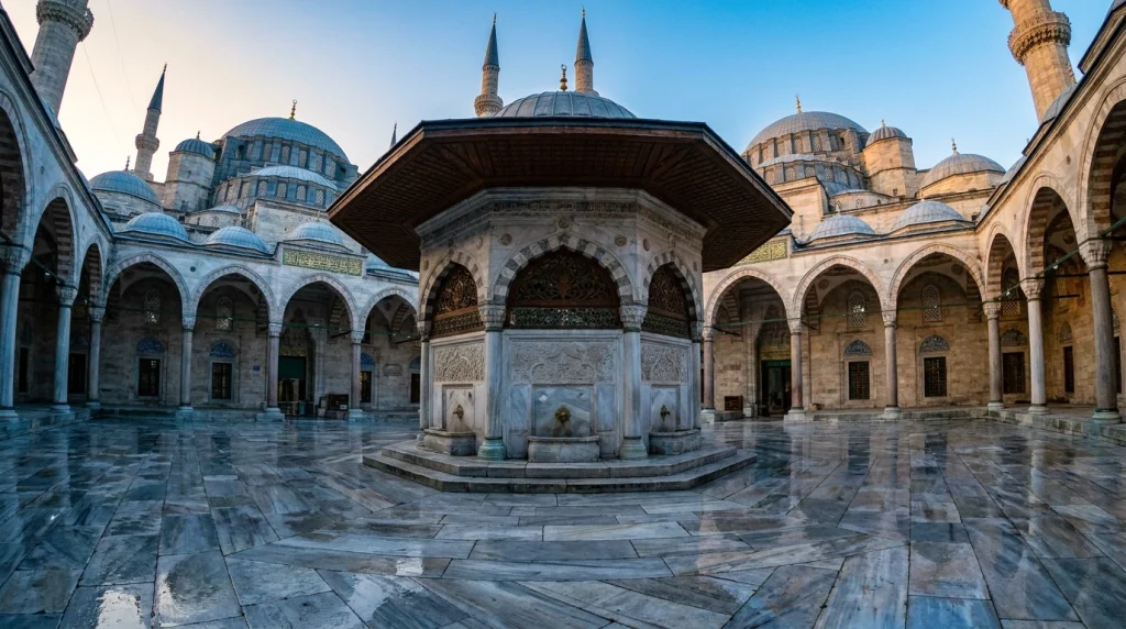 İslami rüya tabirlerini simgeleyen, tarihi bir cami avlusundaki şadırvanda abdest alma sahnesi.